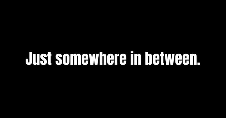 White text on a black background: “Just somewhere in between.” A quote introducing a blog post about emotional flatness and quiet internal struggle.